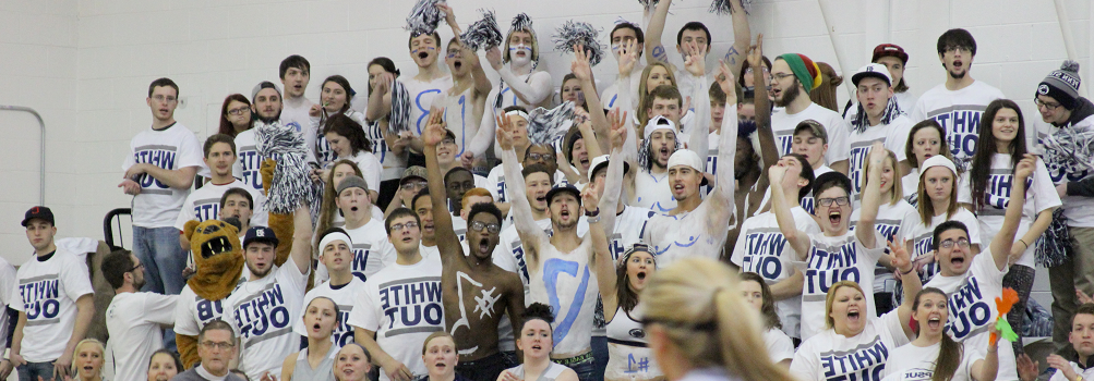 picture of students at white out basketball game cheering